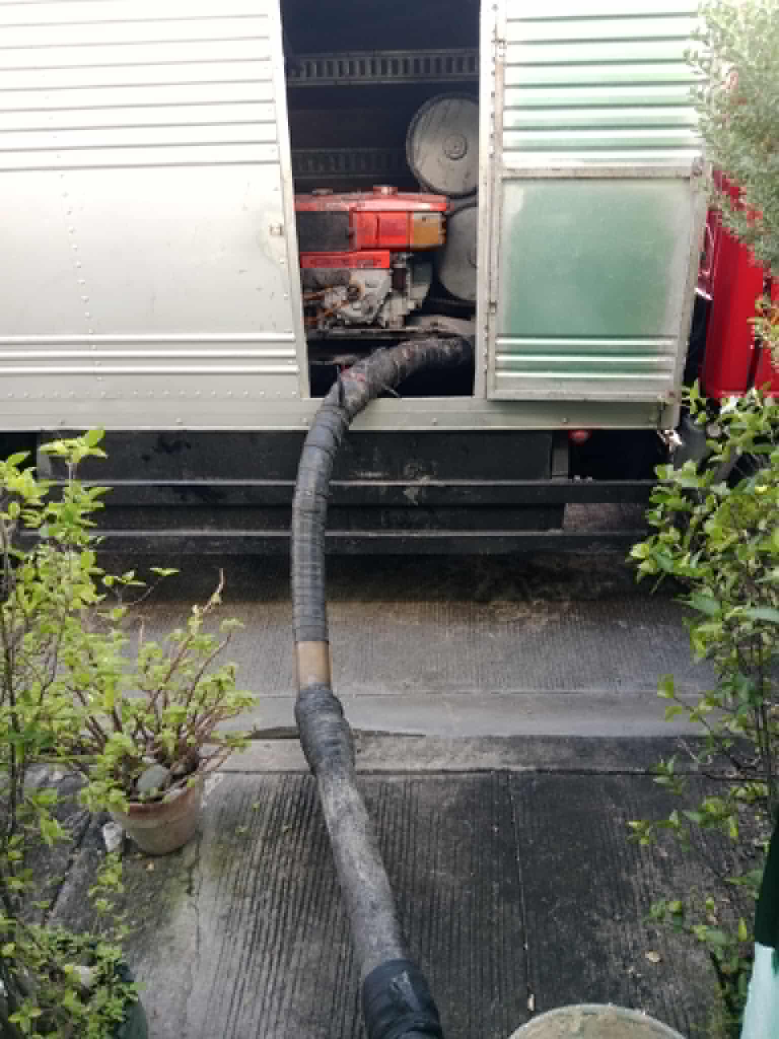Vacuum hose feeding into generator compartment