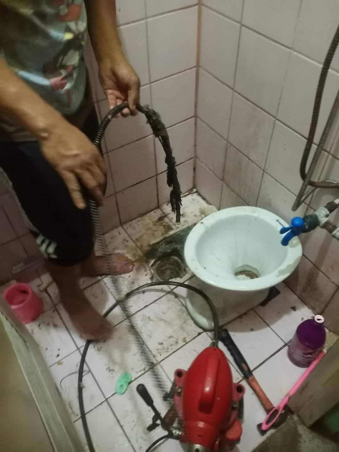 Cleared drain line pulled from a bathroom floor trap